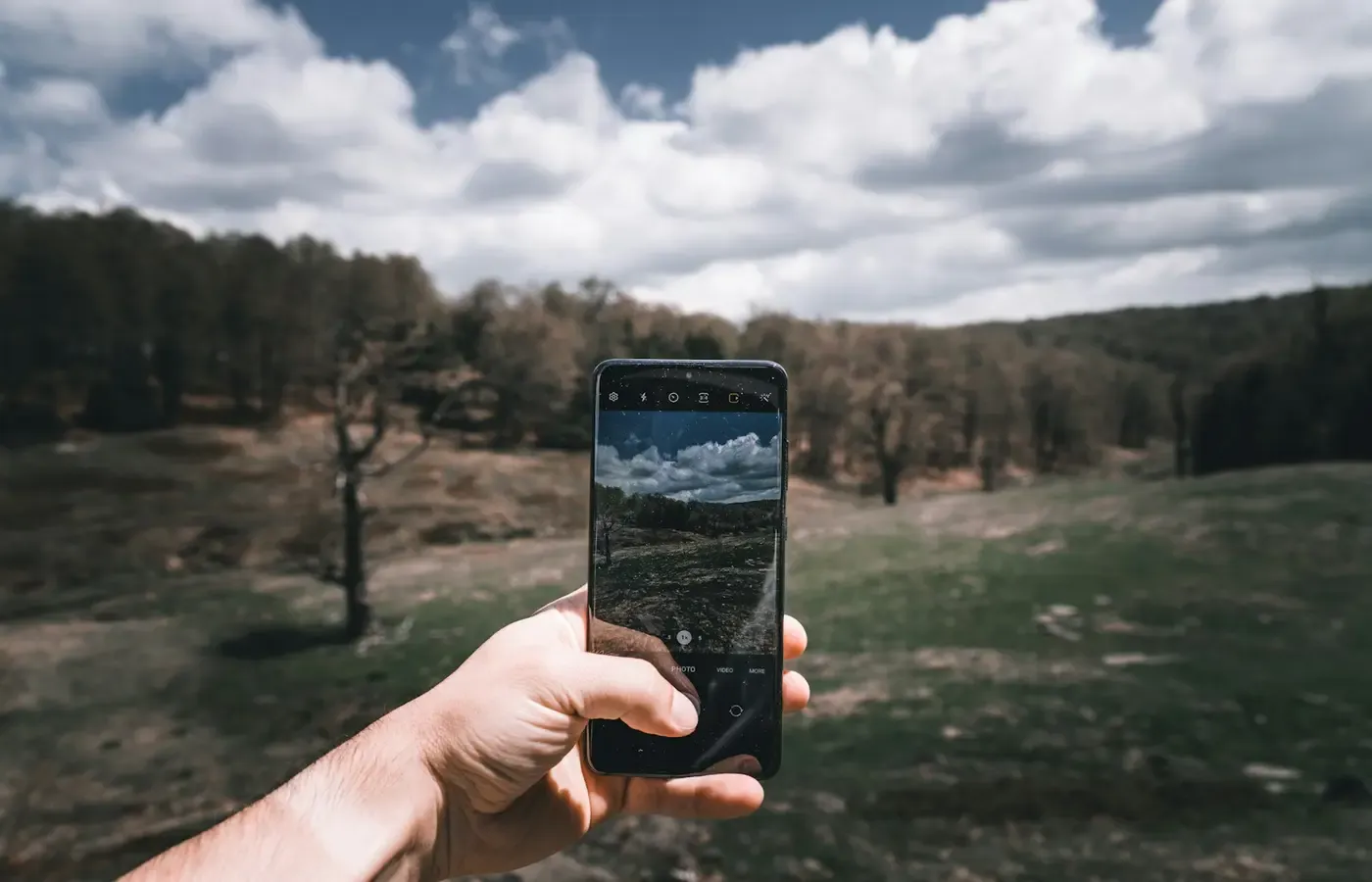A smartphone and a dedicated camera outdoors