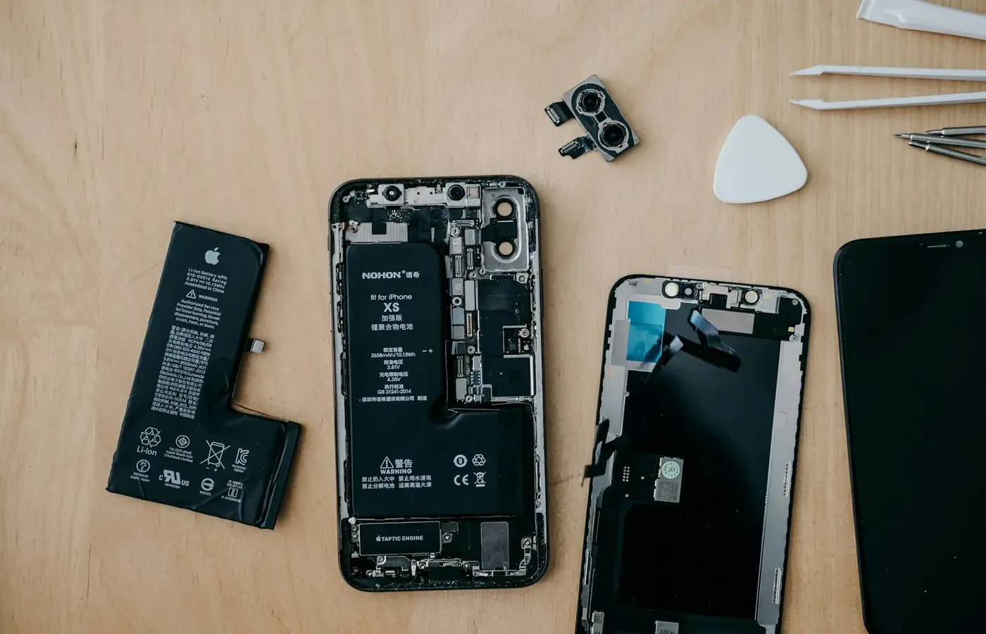 Technician repairing a cracked smartphone